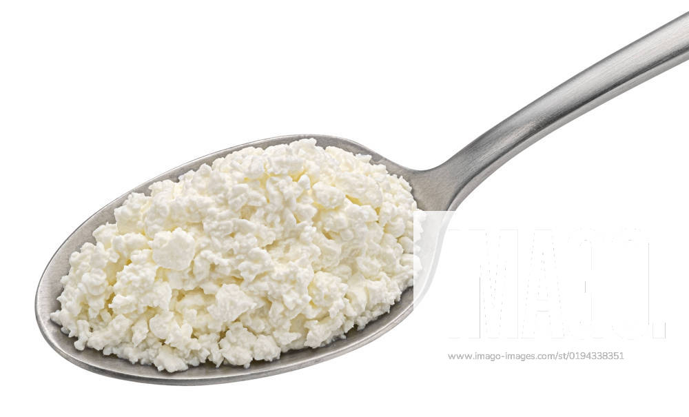 Cottage cheese in spoon isolated on white background Cottage cheese in spoon isolated on white background, top view