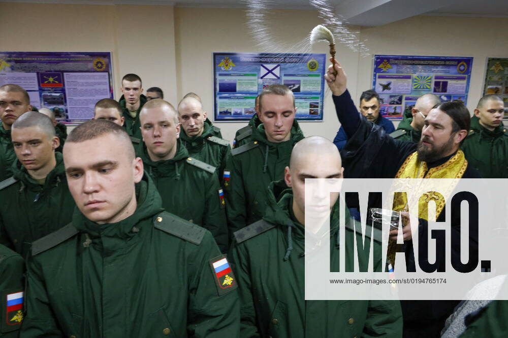 RUSSIA, SIMFEROPOL - NOVEMBER 22, 2022: Archpriest Dimitry Krotkov (R) blesses conscripts at a draft office. The autumn military call-up began in Russia a month later than usual due to a partial mobilisation. The campaign will last from November 1 to December 31, 120 thousand people will be drafted; they will not be sent to the special military operation zone. Sergei Malgavko TASS 56026772