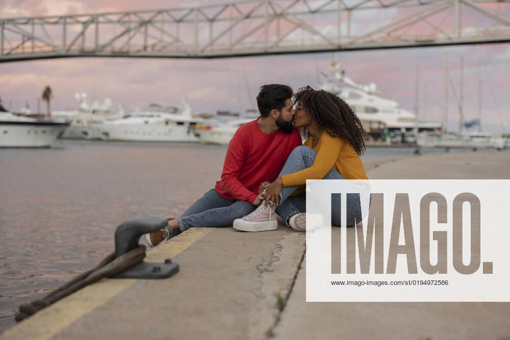 Romantic young couple kissing on promenade at sunset model released, Symbolfoto, JCCMF07993