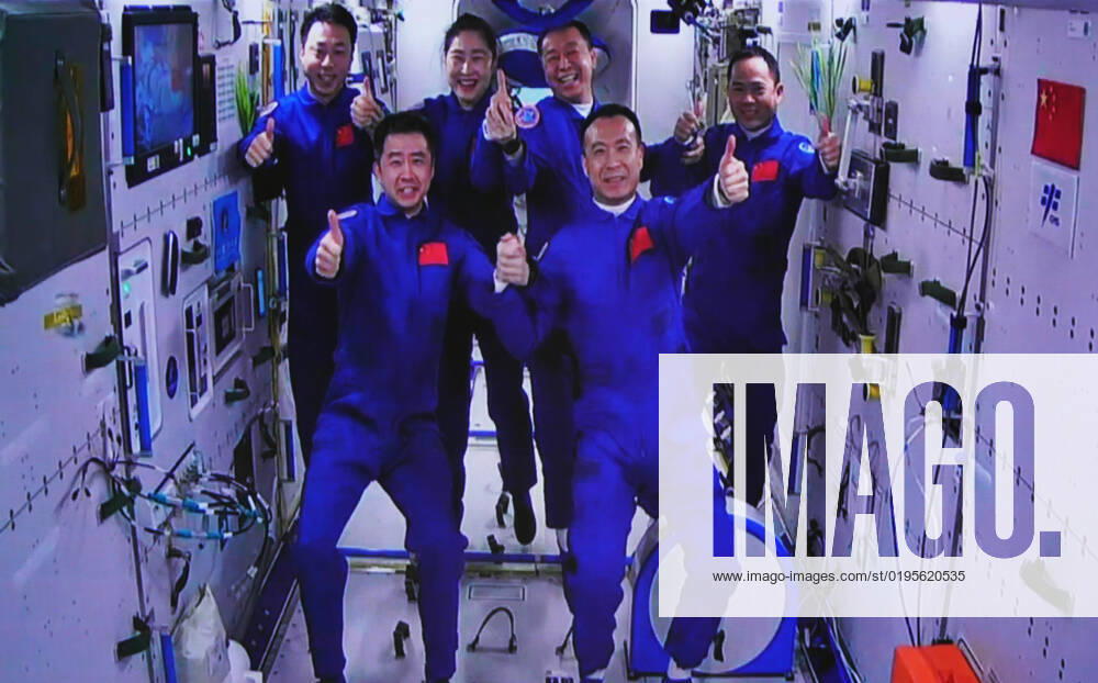 (221130) -- JIUQUAN, Nov. 30, 2022 -- This image captured at the Jiuquan Satellite Launch Center in northwest China shows the Shenzhou-15 and Shenzhou-14 crew taking a group picture with their thumbs up after a historic gathering in space on Nov. 30, 2022. The three astronauts aboard China s Shenzhou-15 spaceship entered the country s space station and met with another astronaut trio on Wednesday, a historic gathering that added the manpower at the in-orbit space lab to six for the first time. Chen Dong, the commander of the Shenzhou-14 crew, opened the hatch at 7:33 a.m. (Beijing Time). The three space station occupants greeted the new arrivals with warm hugs and then they took a group picture with their thumbs up, shouting in chorus