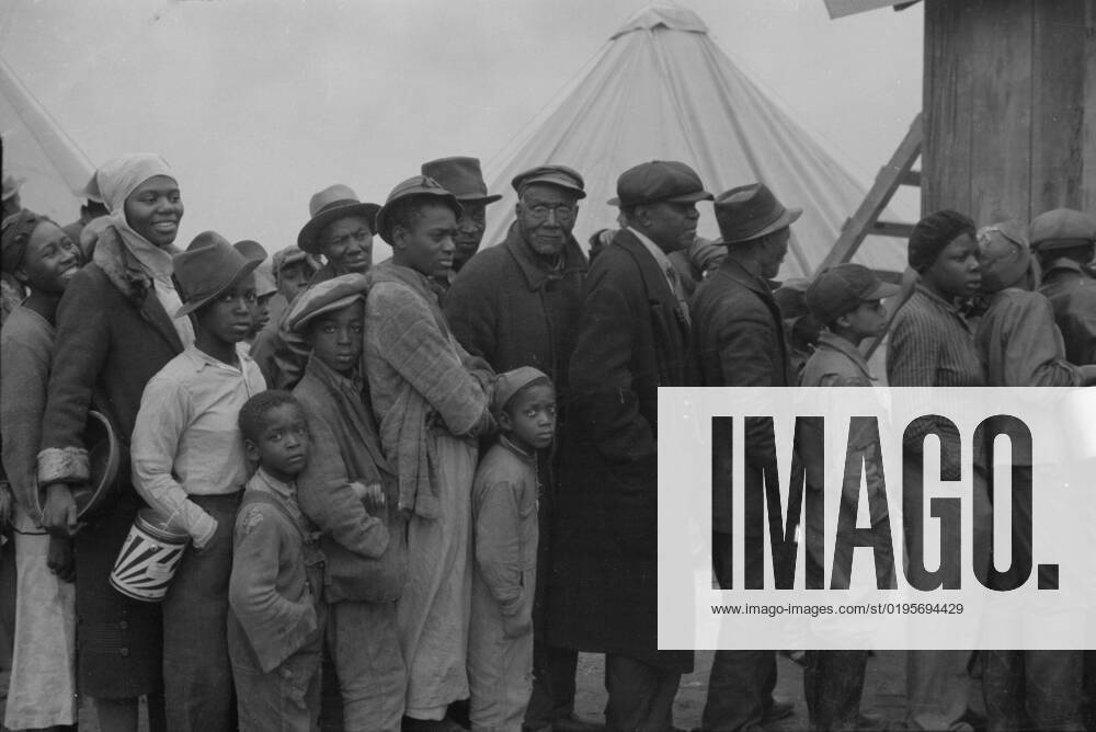 Flood refugees at mealtime, Forrest City, Arkansas, 1937. Creator: Walker Evans.