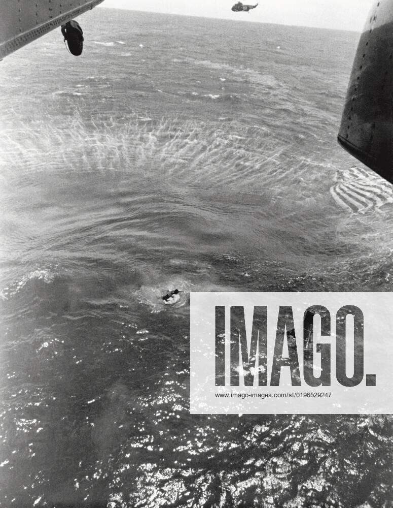 Navy frogmen swim to spacecraft to begin retrieval, Pacific Ocean, 1963. Creator: NASA.