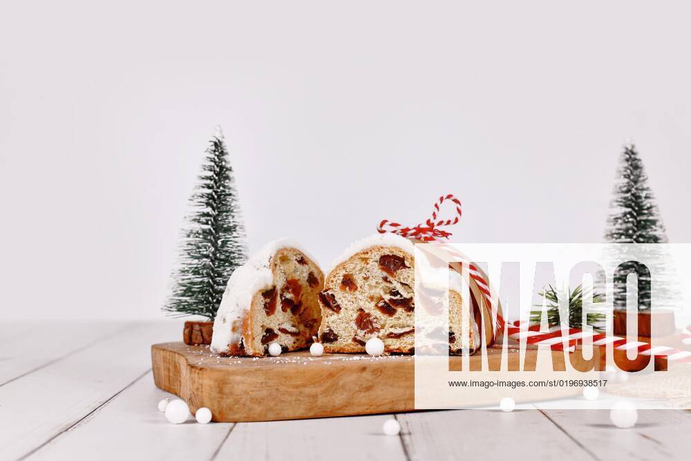 Aufgeschnittener German Stollen, a Fruit bread with nuts, Spices and dried Fruit with Powdered sugar, the traditional to Christmas time served will