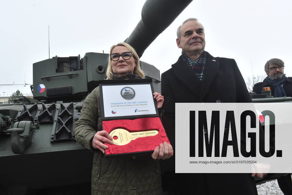 Czech Defence Minister Jana Cernochova (ODS), left, and German Defence Ministry representative Benedikt Zimmer pose with commemorative key, and Czech Ambassador to NATO Jakub Landovsky (right) looks on, as they attend ceremonial acceptance of Leopard 2A4 tank Czechia gets from Germany for its help to Ukraine, which took place in military barracks in Praslavice, Czech Republic, on Wednesday, December 21, 2022. (CTKxPhoto LudekxPerina) CTKPhotoP2022122102766 P2022122102766