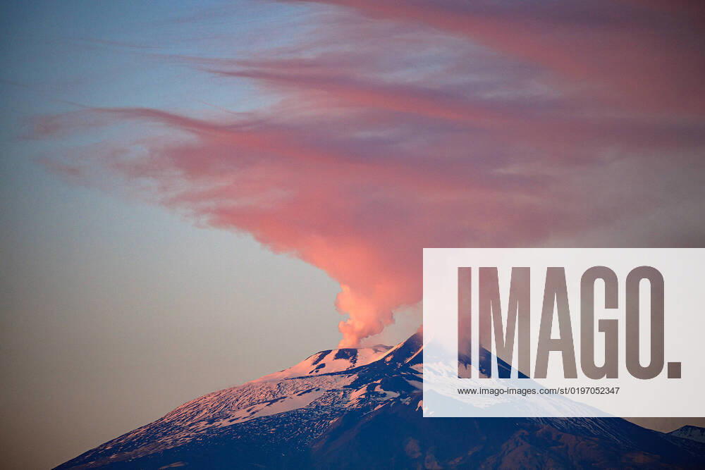Catania, The eruption of Etna intensifies with the flow pouring into the Valle del Bove. Today even the crater the abyss has not stopped degassing creating a fantastic sunset Editorial Usage Only