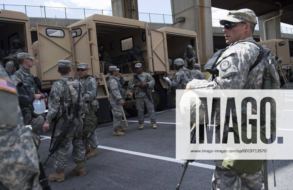 Members of the Maryland National guard stage in a parking lot near Orioles Park in Camden Yards in Baltimore, Maryland on April 29, 2015. Protesters continue to march throughout Baltimore in the wake of Freddie Gray s death. The late 25-year-old died earlier this month from a spinal injury while in police custody. BAL20150429358 KEVINxDIETSCH