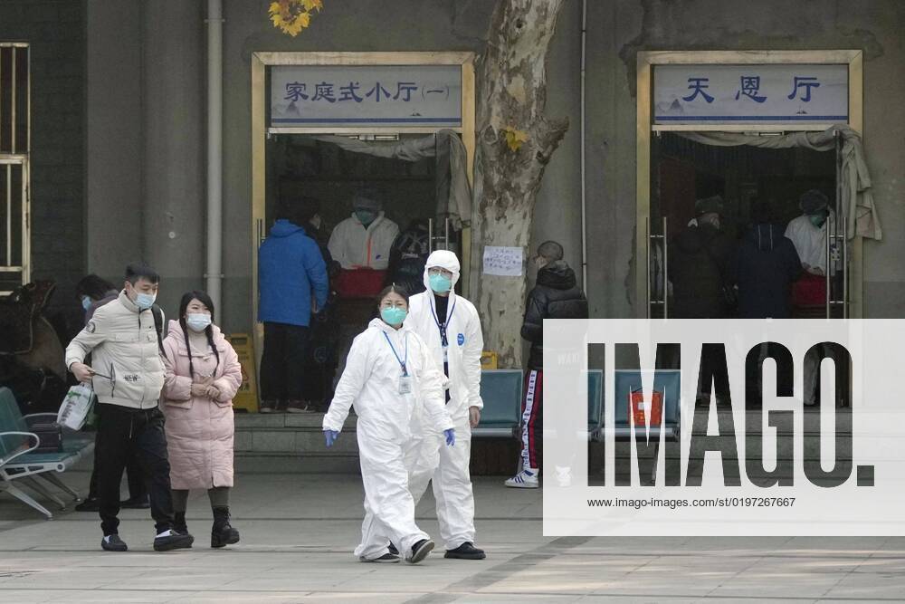 Wuhan amid COVID surge Officials in protective gear walk in front of a funeral hall in Wuhan on Dec. 29, 2022, amid a surge in COVID-19 cases. The Chinese government eased its strict antivirus measures earlier in the month. A14AA0001380154P