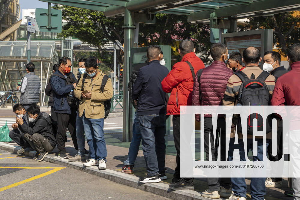 Daily Life In Macau Commuters wearing face masks while waiting for a bus at a bus stop on December 29, 2022 in Macau, China. Macau Macau