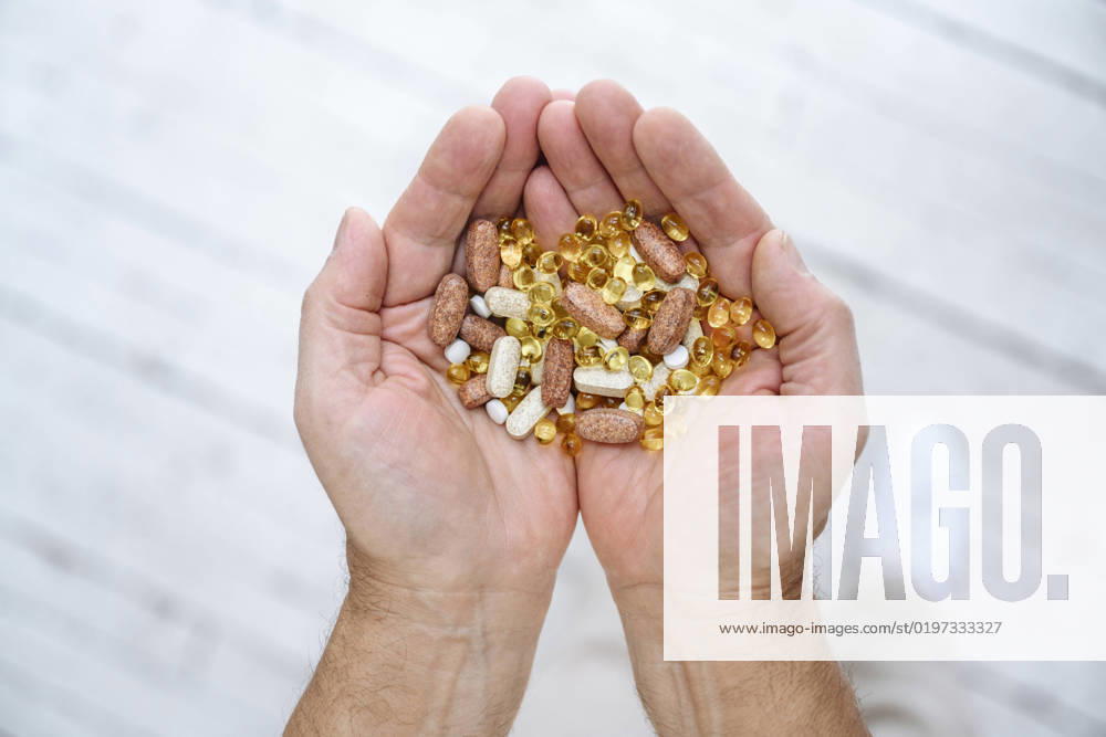 Senior man holding pills in cupped hands model released, Symbolfoto property released, EYAF02376