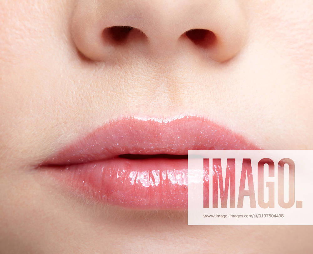 Closeup macro portrait of female part of face. Human woman lips with day beauty makeup Human mouth and nose. Closeup macro portrait of female part of face. Woman lips with day beauty makeup.