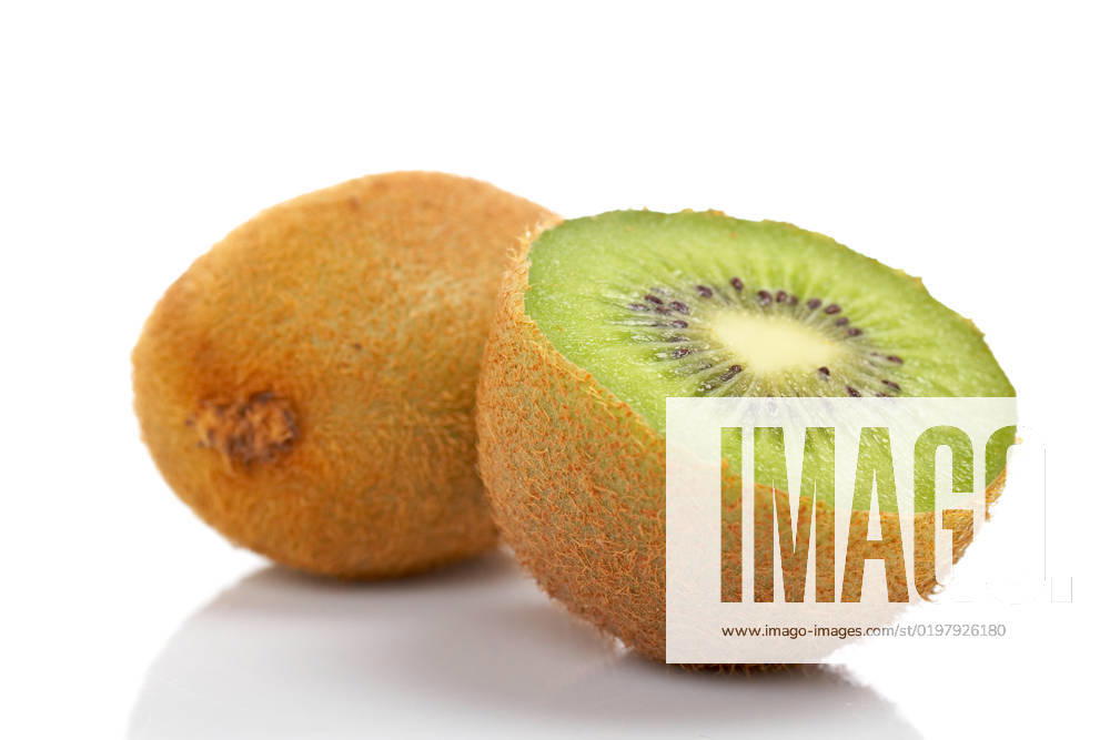 Two half of kiwi fruit reflected on white background. Shallow DOF