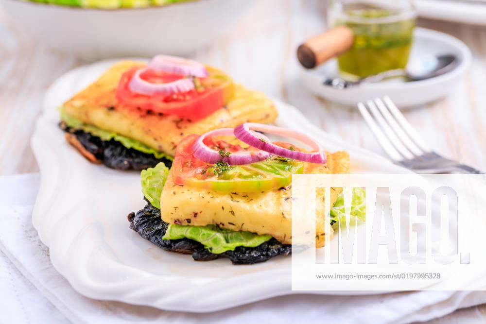 Portobello mushroom open sandwich or burger with grilled halloumi cheese and onions Portobello mushroom open sandwich or burger with grilled halloumi cheese and onions