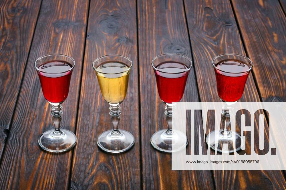 Vodka infused with berries, Vodka infused with berries on wooden background (photo with shallow depth of field), Vodka infused with berries on wooden background (photo with shallow depth of field), 03.10.2022,