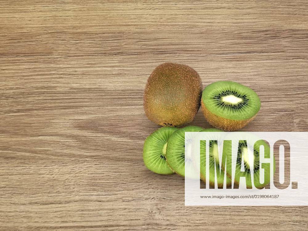 Kiwi splits kiwi pieces on a wooden floor. with space for text, Kiwi splits kiwi pieces on a wooden floor. with space for text, Kiwi splits kiwi pieces on a wooden floor. with space for text, 04.10.2022,