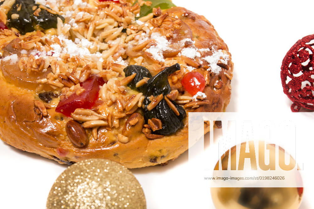 Portuguese King Cake is a famous christmas celebration cake with dry nuts and crystalized fruits. , 25769734.jpg, almond, background, baked, bakery, cake, christmas, colorful, crystallized, cuisine, dry, fig, fluffy, food, fruit, gastronomy, glace, grape, icing, isolated, king, nut, pastry, pine, pinea, pinus, portugal, portuguese, raisin, round, seasonal, seed, sugar, sweet, tasty, top, tradition, traditional, typical, view, white, xmas, balls,
