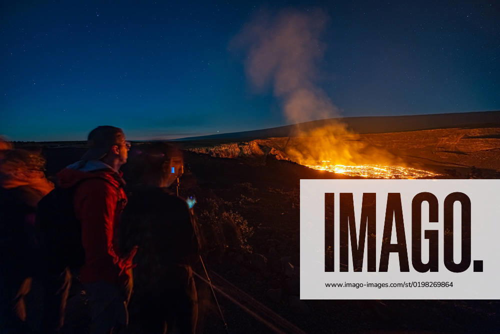 VOLCANO, HI - January 7, 2023: Spectators observe the eruption pictured as Hawaii?s Kilauea volcano eruption continued after re-erupting on January 5th in Volcano, HI on January 7, 2023.