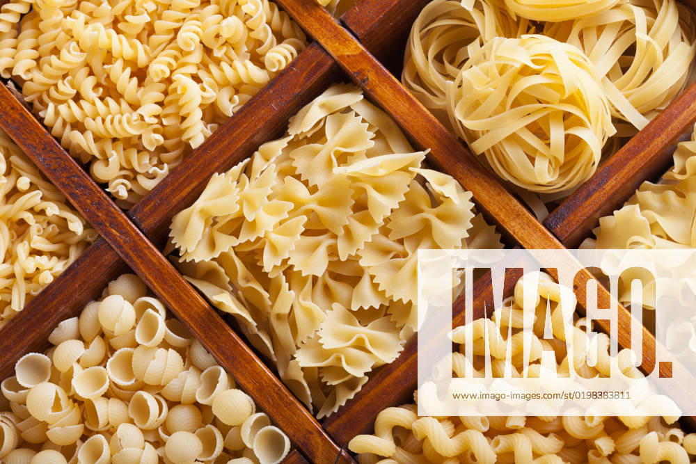 Assorted pasta in wooden compartments - italian food variety