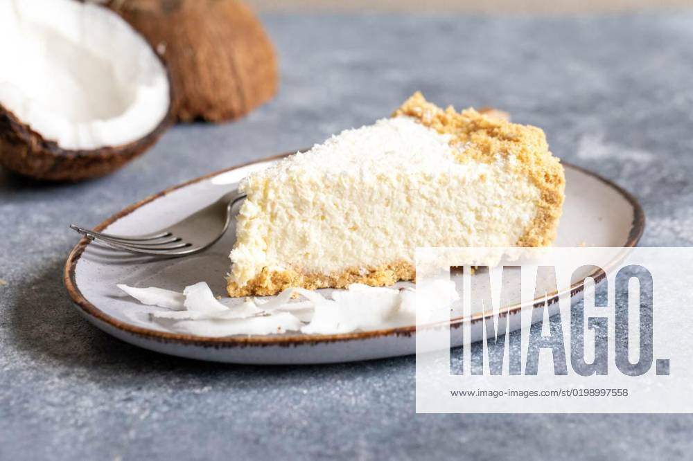 Piece of coconut cheesecake on a plate with fresh coconut, piece of coconut cheesecake on a plate with fresh coconut., piece of coconut cheesecake on a plate with fresh coconut., 05.12.2022,