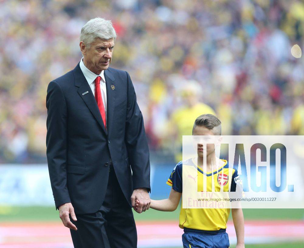 Arsenal s manager Arsene Wenger walks out with a mascot FA Cup Final - Arsenal vs Aston Villa - Wembley Stadium - England - 30th May 2015 - Picture David Klein Sportimage .