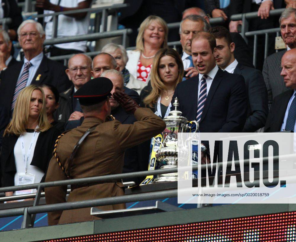 The FA Cup Final - Arsenal v Aston Villa . . London, UK . . 30.05.2015 A soldier salutes Aston Villa fan Prince William, Duke of Cambridge, after delivering the FA Cup.
