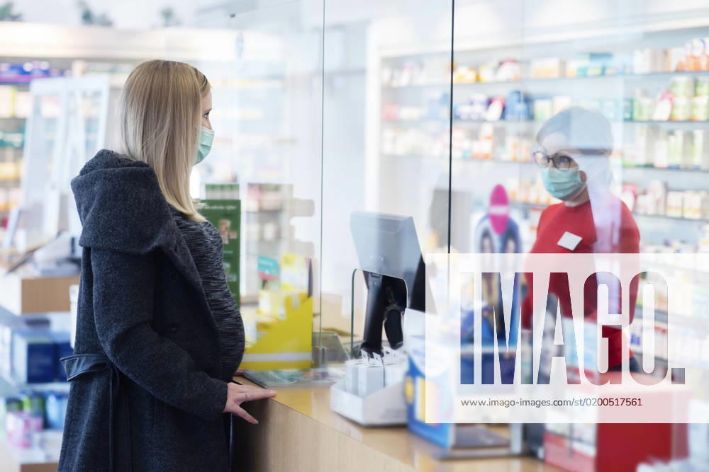 Pharmacist talking with customer standing by counter in medical store model released, Symbolfoto property released, NJAF00150