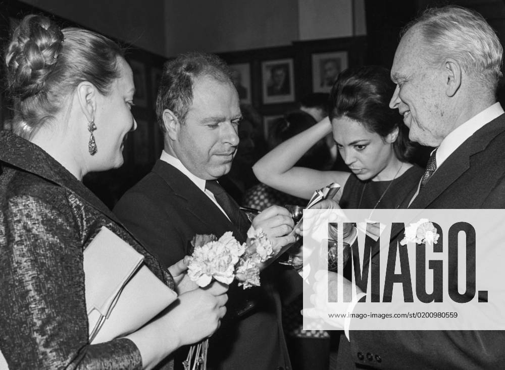 Moscow, USSR. April 2, 1964. Director of the Royal Shakespeare Theatre Peter Brook signs an autograph for Nikolay Kedrov, main director of the Gorky Moscow Art Theatre, (L-R) after the King Lear performance on stage of a branch office of the Gorky MAT. Natasha Parry, wife of P. Brook (C) attends the event. Alexander Konkov TASS 18068070