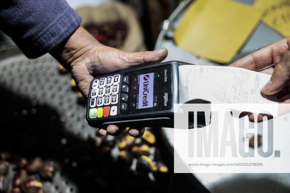 Rome. Roast chestnut with digital payment made with electronic payment instruments: via Mobile Remote Payment, Mobile POS, Contactless, debit, and prepaid cards. 1007_48_MIN131222_5