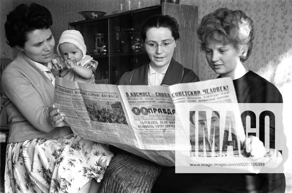 Moscow. USSR. June 15, 1963. Spouses of Soviet cosmonauts Marina Popovich, Valentina Gagarina, Valentina Bykovskaya (L-R) read an article about a group space flight of V.Bykovsky and V.Tereshkova in Pravda newspaper. Marina Popovich holds Valery, a son of Valery Bykovsky and Valentina Bykovskaya. Valentin Cheredintsev TASS 277050