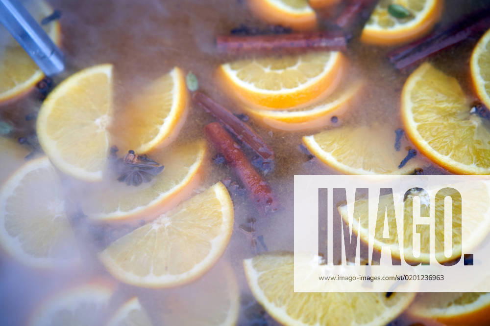 Closeup of mulled wine citrus fruit, preparing in big old metal kettle on fire, above view, Traditional Christmas fair market beverage , 35320654.jpg, mood, wine, warm, punch, relax, smoke, apple, prepare, seasonal, boiler, heat, steam, seasoning, xmas, adding, citron, condiment, festive, piece, christmas, drink, alcohol, holiday, hot, orange, spice, pot, pan, cinnamon, slice, making, red, anise, aromatic, cosiness, grog, metal, beverage, fruit, traditional, winter, cooking, mulled, citrus