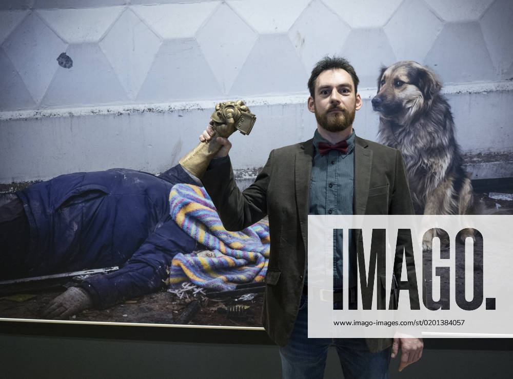 Czech photographer Vojtech Darvik Maca poses with the Czech Press Photo 2022 main prize in front of his winning photo from the massacre in Bucha, Ukraine, on January 31, 2023, in Prague, Czech Republic. (CTKxPhoto MichaelaxRihova) CTKPhotoP2023013108254 P2023013108254