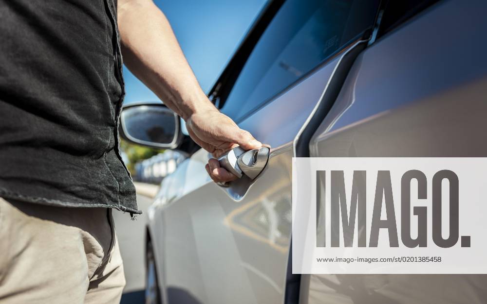 The Hands open the Car door Close-up the male Hand, the the Car door opens Vehicle owners the open the Door with the Keys Car Rental Concept