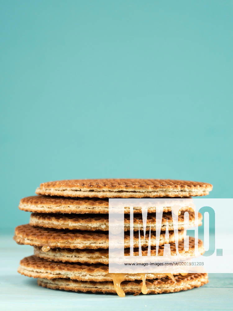 Stroopwafels or caramel Dutch Waffles Stroopwafels or caramel Dutch Waffle close up on turquoise wooden background
