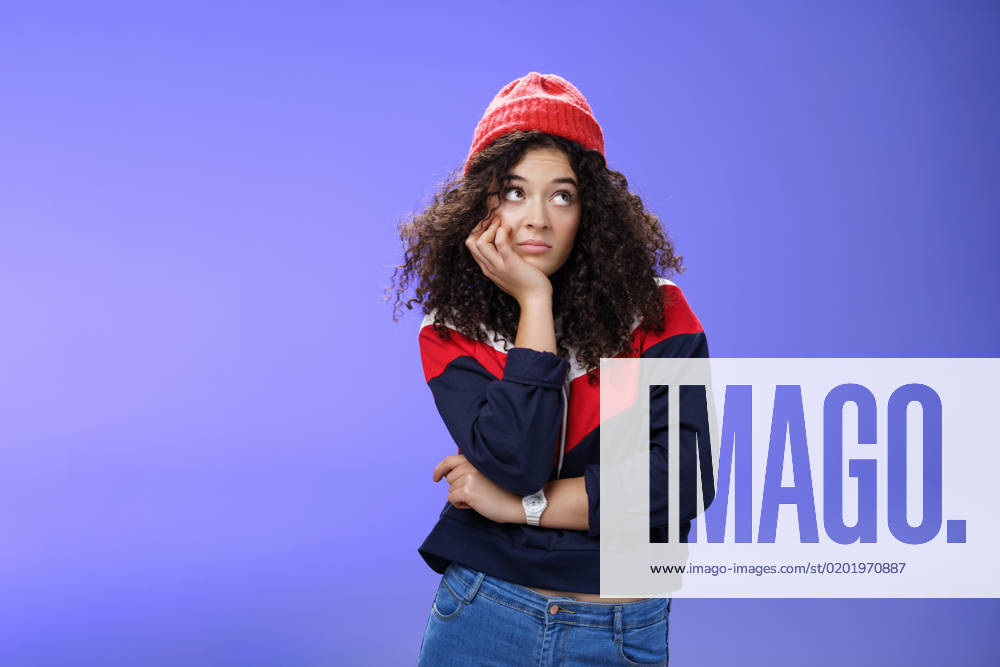 Portrait of frustrated and bored lonely girl with curly hair in winter hat holding hand across chest leaning head on palm, looking silly and gloomy at upper right corner, thinking feeling boredom., model released, , 43178700.jpg, woman, girl, female, lady, girlfriend, bored, sad, unhappy, sorrow, nostalgic, lonely, upset, boredom, beanie, watch, winter, blue, hat, confident, independent, feminine, self-assured, joyful, fall, autumn, weather, smiling, happy, emotion, emotional, satisfied, pleased, delighted, tender, cute, expression, curly, yellow, advertisement, background, adult, attractive, beautiful, fashion, beauty, casual, caucasian, hair, lifestyle, model