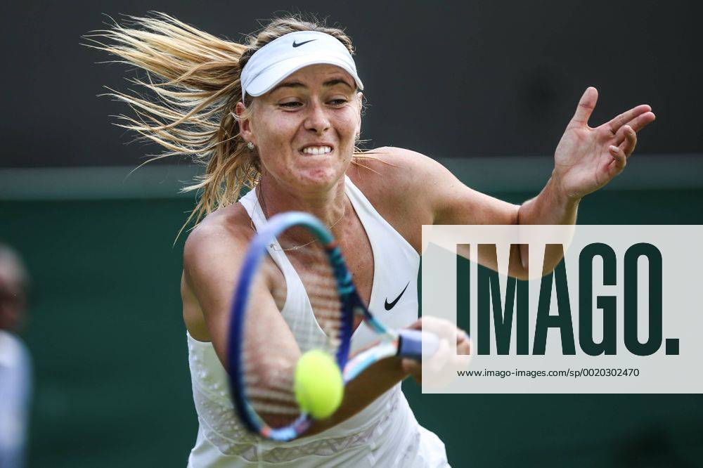 (150702) -- LONDON, Maria Sharapova of Russia returns the ball to Richel Hogenkamp of the Netherlands during the women s singles second round match at 2015 Wimbledon Tennis Championships in London, Britain, July 1, 2015. Sharapova won 2-0. ) (SP)BRITAIN-LONDON-TENNIS-WIMBLEDON CHAMPIONSHIPS TangxShi