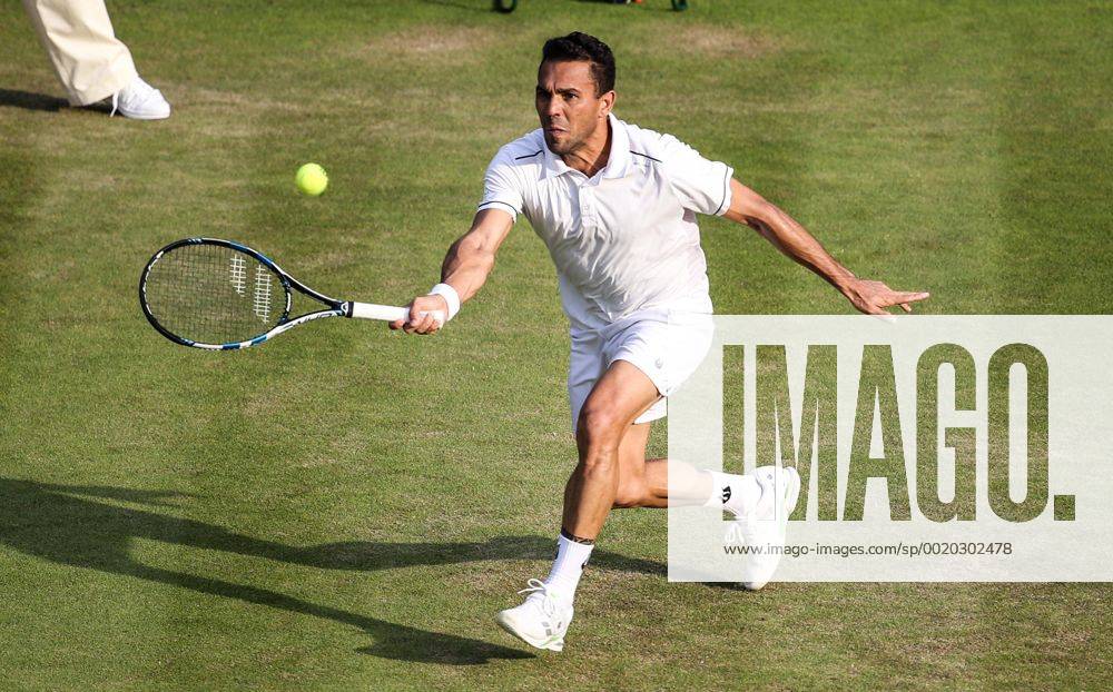 (150702) -- LONDON, Victor Estrella Burgos of the Dominican Republic returns the ball to Stan Wawrinka of Switzerland during the men s singles second round match at 2015 Wimbledon Tennis Championships in London, Britain, July 1, 2015. Wawrinka won 3-0. ) (SP)BRITAIN-LONDON-TENNIS-WIMBLEDON CHAMPIONSHIPS TangxShi