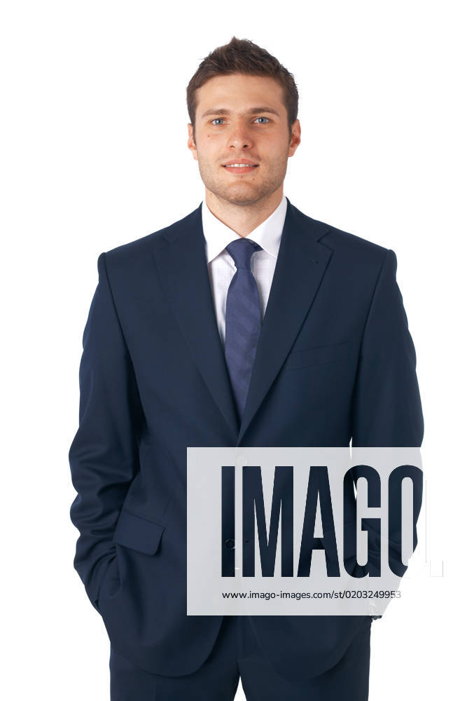 Portrait of a young businessman standing with his hands in the pockets.