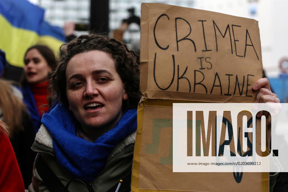 A demonstrator holds a sign reading Crimea is Ukraine during a protest in occasion of the one-year anniversary of Russia s invasion of Ukraine in Brussels, Belgium, February 25, 2023. Brussels Belgium - ZUMAm177 20230225_zip_m177_008