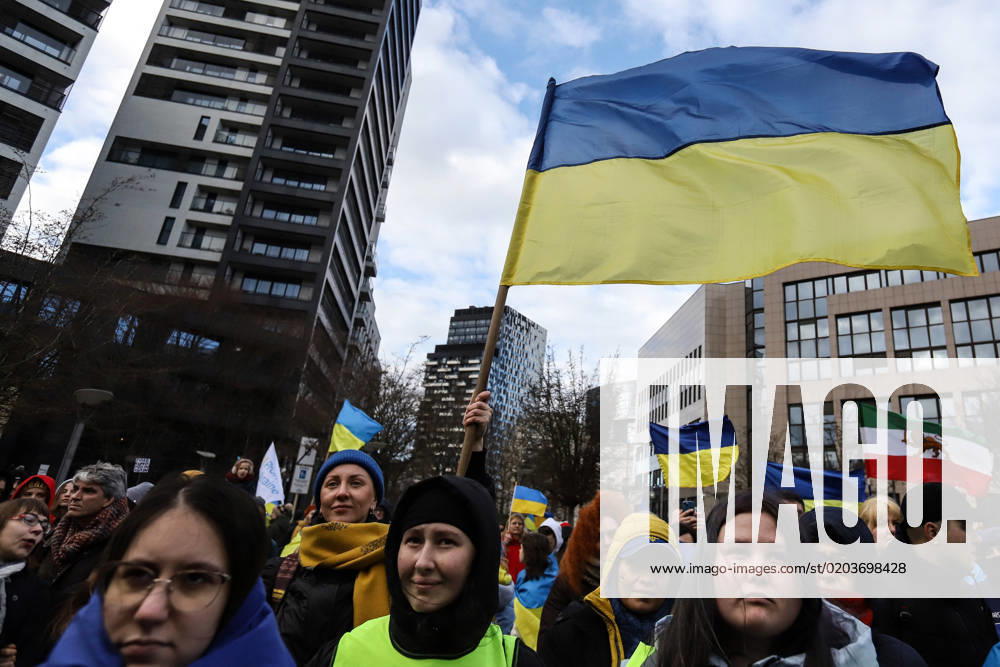 Demonstrators hold signs and Ukrainian flags during a demonstration in occasion of the one-year anniversary of Russia s invasion of Ukraine in Brussels, Belgium, February 25, 2023. Brussels Belgium - ZUMAm177 20230225_zip_m177_025