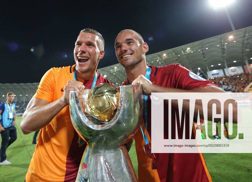 Turkey Supercup match between Galatasaray and Bursaspor at Osmanli Stadium in Ankara, Turkey on August 08, 2015. Final Score : Galatasaray 1 - Bursaspor 0 Pictured: Galatasaray s players celebrates their Turkish SuperCup championship at the Osmanli Stadium in Ankara on August 08, 2015. Lukas Podolski (L) and Wesley Sneijder (R) with Trophy.