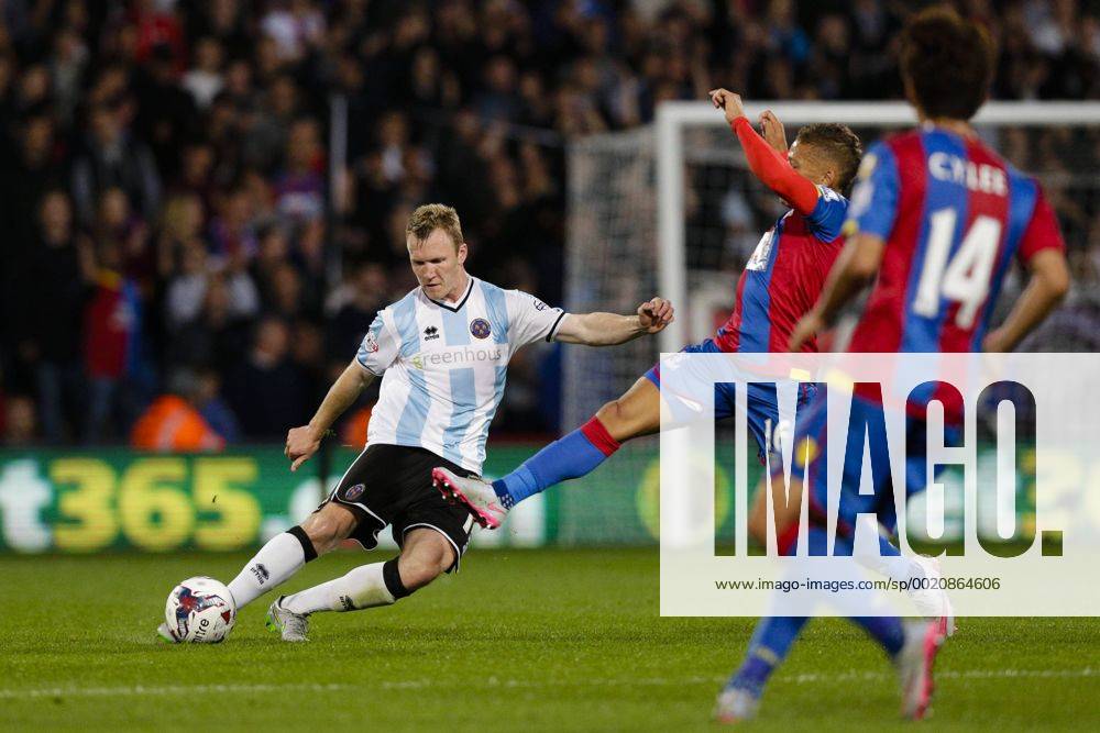London, England. Capital One Cup 2nd Round. Crystal Palace versus Shrewsbury. Shrewsbury Town s Mark Ellis makes a clearance under pressure from Crystal Palace& x2019;s Dwight Gayle Mercerx ActionPlus11653613