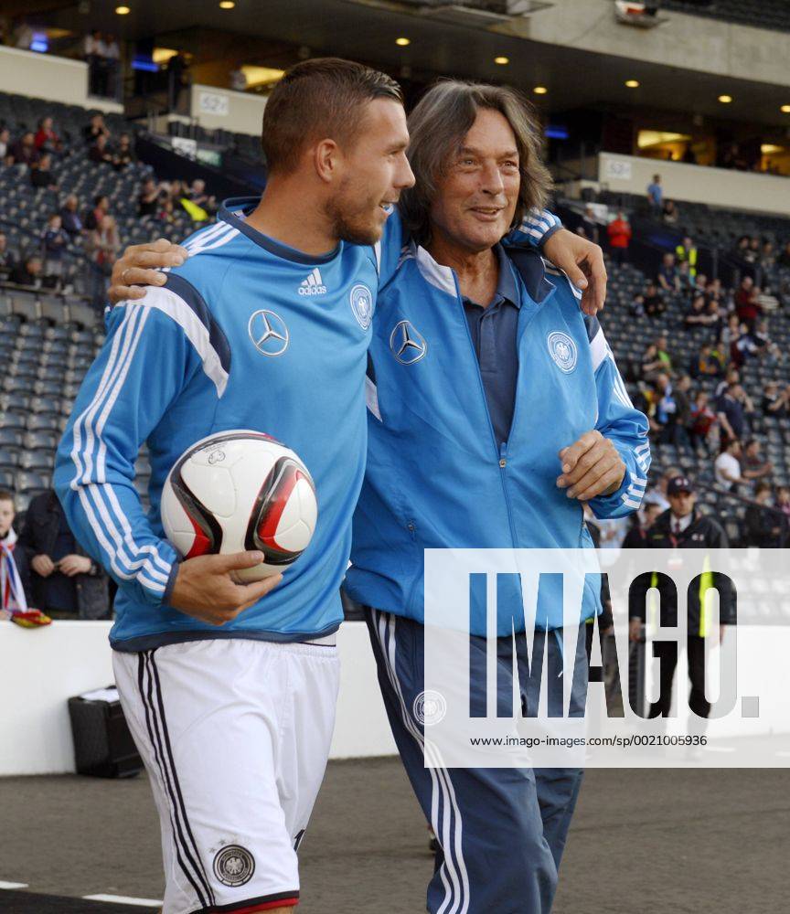 Fussball Europameisterschafts-Qualifikation, 8.Spieltag, Schottland - Deutschland, im Hampden Park in Glasgow (Schottland). Lukas Podolski (Deutschland) umarmt Mannschaftsarzt Dr. Hans-Wilhelm Müller-Wohlfahrt (Deutschland) vor dem Spiel.
