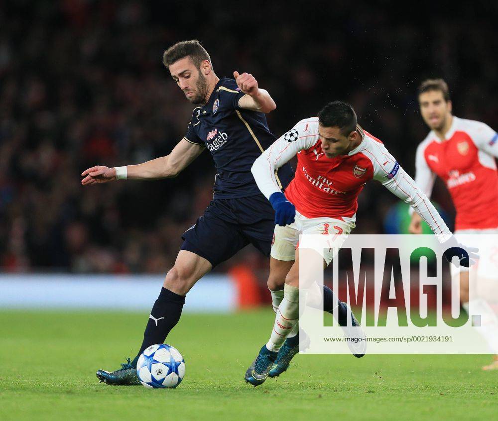 Arsenal s Alexis Sanchez tussles with Dinamo Zagreb s Ivo Pinto UEFA Champions League- Arsenal v Dinamo Zagreb - Emirates Stadium - England - 24th November 2015 - Picture David Klein Sportimage .