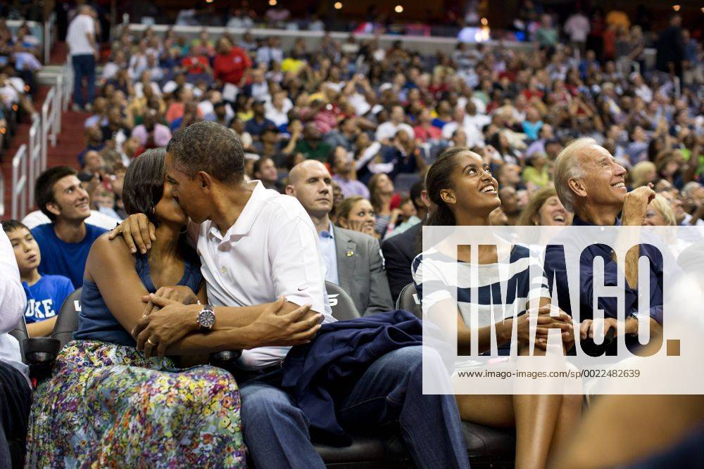 Washington, District of Columbia, U.S. - President BARACK OBAMA kisses First Lady MICHELLE OBAMA for the Kiss Cam while attending the U.S. Men s Olympic basketball team s game against Brazil at the Verizon Center. Vice President JOE BIDEN, right, and MALIA OBAMA, next to the president, look up at the jumbotron.. - ZUMAz03 July 16 2012 Washington District of Columbia U S President Barack Obama Kisses First Lady Michelle Obama for The Kiss Cam while attending The U S Men S Olympic Basketball Team S Game against Brazil AT The Verizon Center Vice President Joe Biden Right and Malia Obama Next to The President Look up AT The jumbotron ZUMAz03 July 16 2012 Washington District of Columbia U S President BARACK OBAMA kisses First Lady MI - ZUMA2