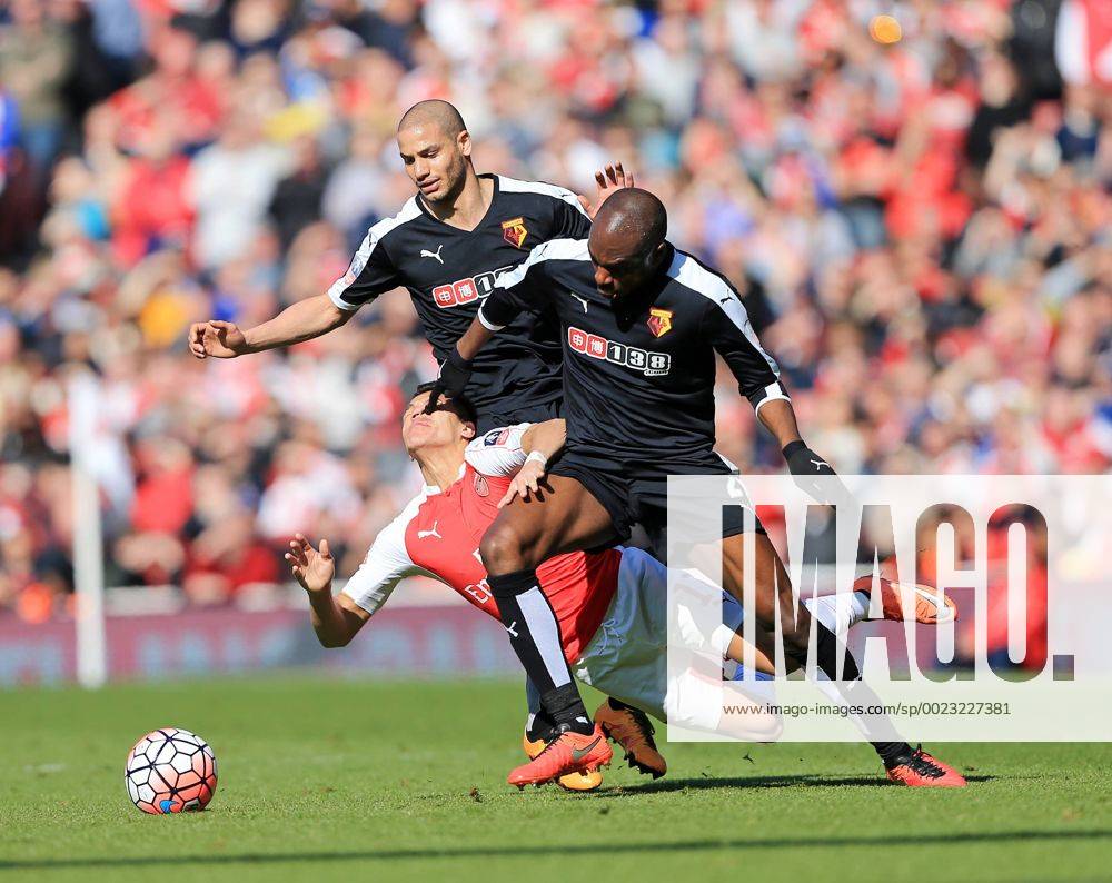Arsenal s Alexis Sanchez tussles with Watford s Allan Nyom and Adlene Guedioura during the Emirates FA Cup match at The Emirates Stadium. Photo credit should read: David Klein Sportimage .