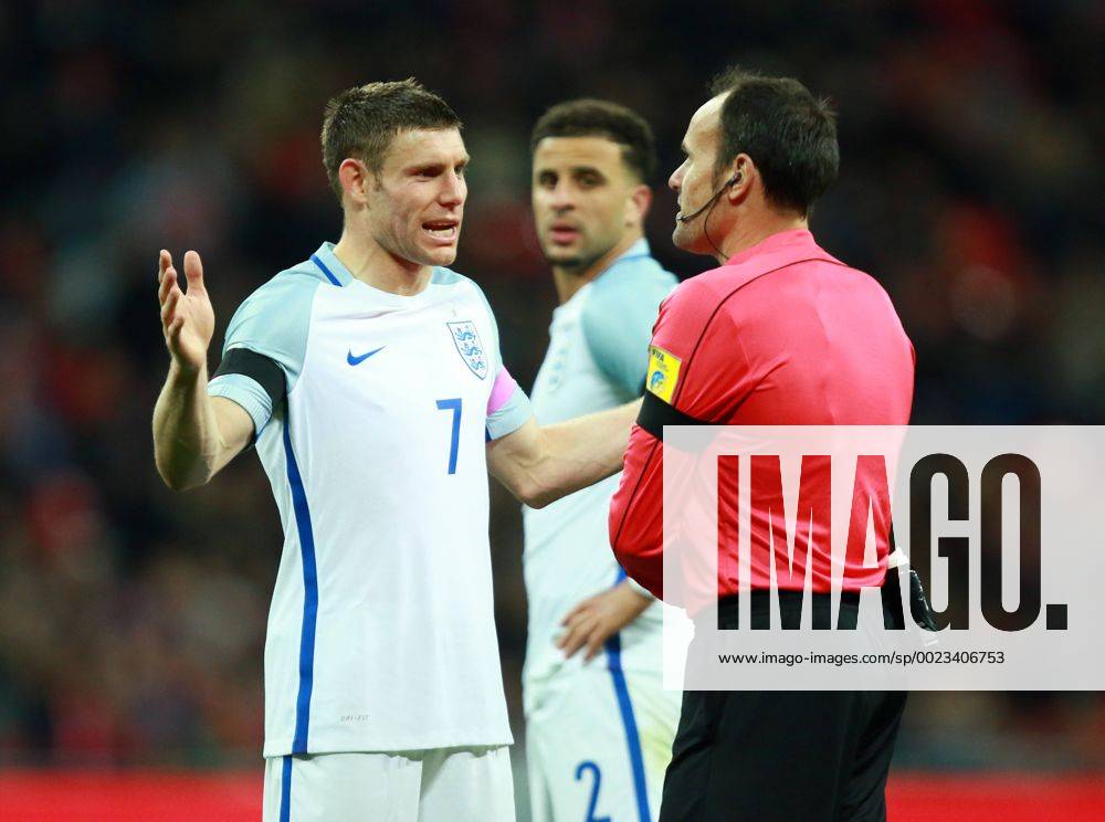 England v Netherlands . . Wembley, London, UK . . 29.03.2016 James Milner (E) speaks to Antonio Miguel Mateu Lahoz about the penalty decision, with Kyle Walker (E) in the background.