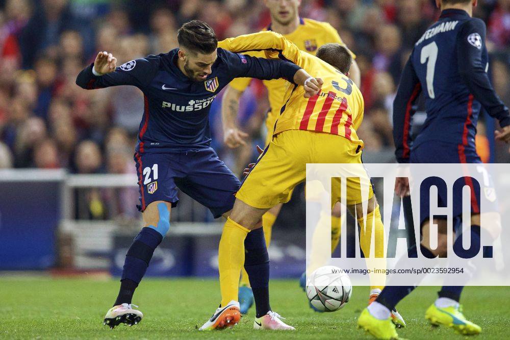 (L-R) Yannick Carrasco of Club Atletico de Madrid, Gerard Pique of FC Barcelona Barca during the UEFA Champions League quarter-final match between Atletico Madrid and FC Barcelona on April 13, 2016 at the Vicente Calderon stadium in Madrid, Spain. Atletico Madrid v FC Barcelona UEFA Champions League 2015 2016 IVx 5311896