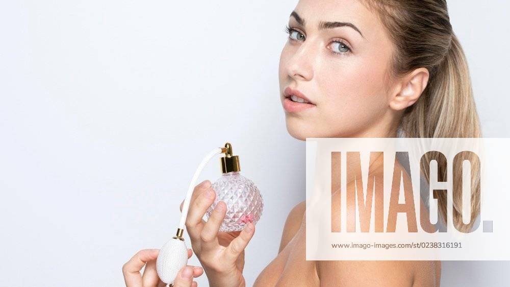 Front view woman with perfume bottle