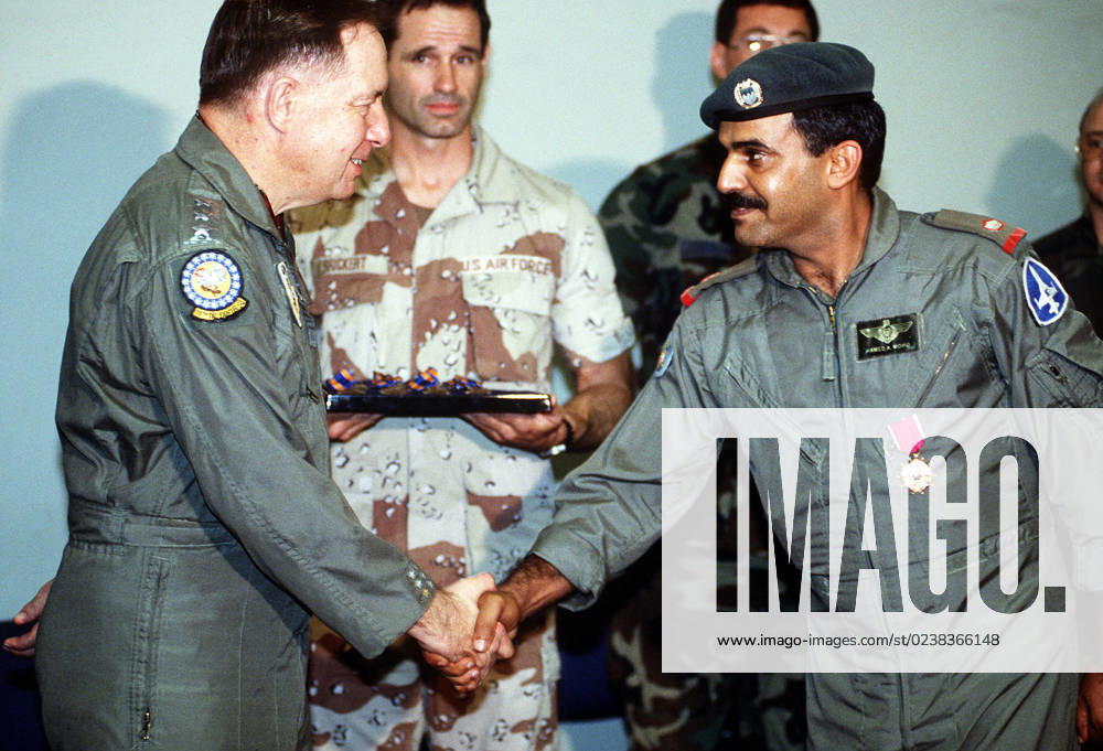 LT. GEN. Charles Horner, commanding general, U.S. Central Air Force, congratulates MAJ. Hamad Bin Abdulla Al-Khalifa, Shaikh Isa squadron commander, after awarding him the Legion of Merit for his efforts in support of coalition forces during Operation Desert Storm. Nineteen Bahraini pilots are receiving air medals during the ceremony.. Subject Operation Series: DESERT STORM Country: Bahrain(BHR)