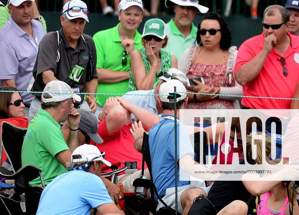 Charlotte, NC, USA - A fan is hit in the face with a ball driven by golfer Roberto Castro to the 18th green during the Wells Fargo Championship on Sunday, May 8, 2016, at Quail Hollow Club in Charlotte, N.C. Wells Fargo Championship - ZUMAm67_