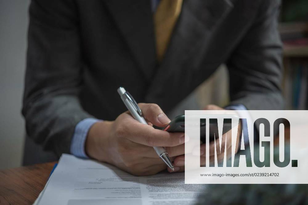 Businessman hand smart phone and document contract and workplace report marketing on desk., businessman hand smart phone and document contract and workplace report marketing on desk., businessman hand smart phone and document contract and workplace report marketing on desk., 13.01.2023,